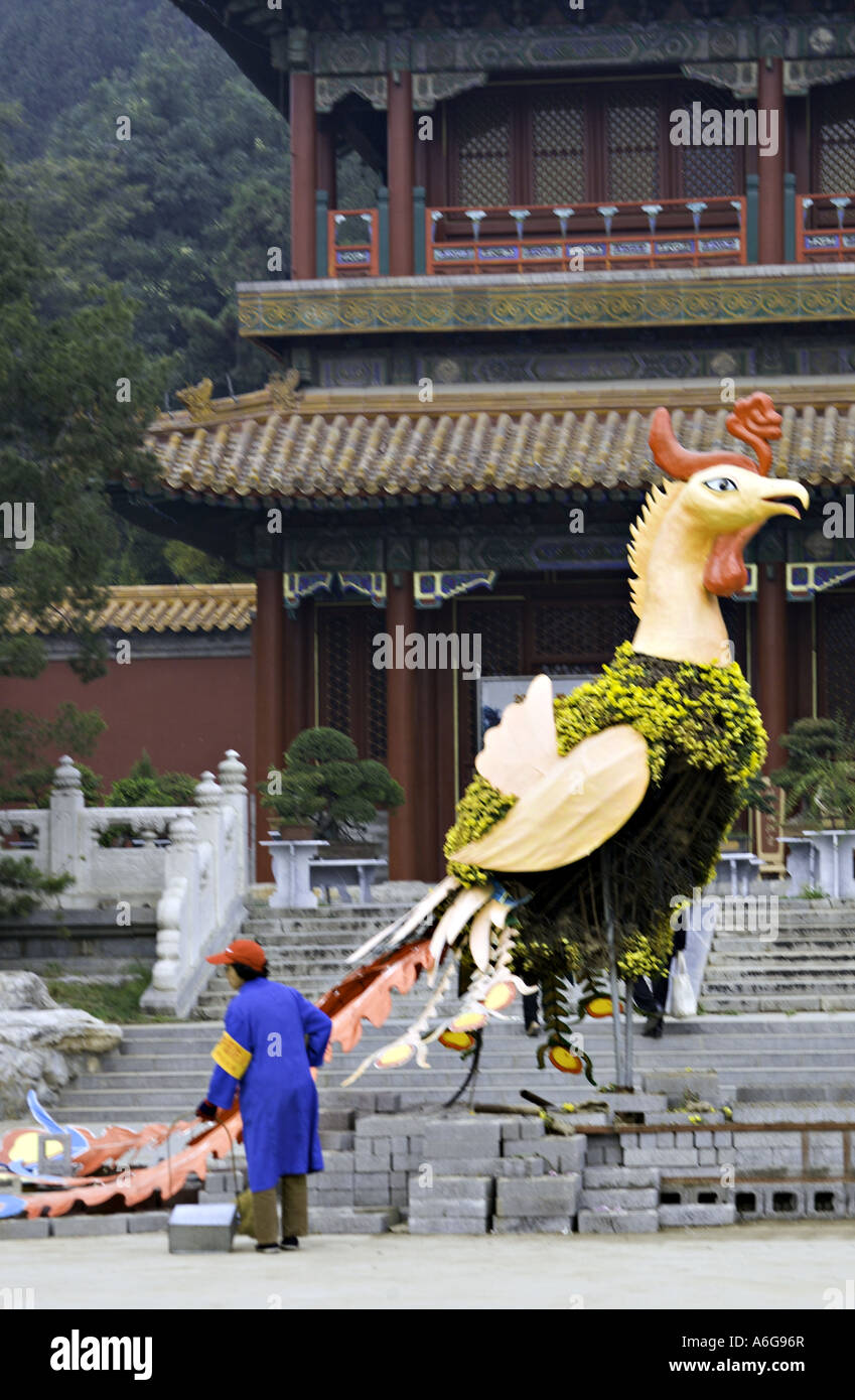 CHINA BEIJING Female Chinese park worker cleaning around giant bird
