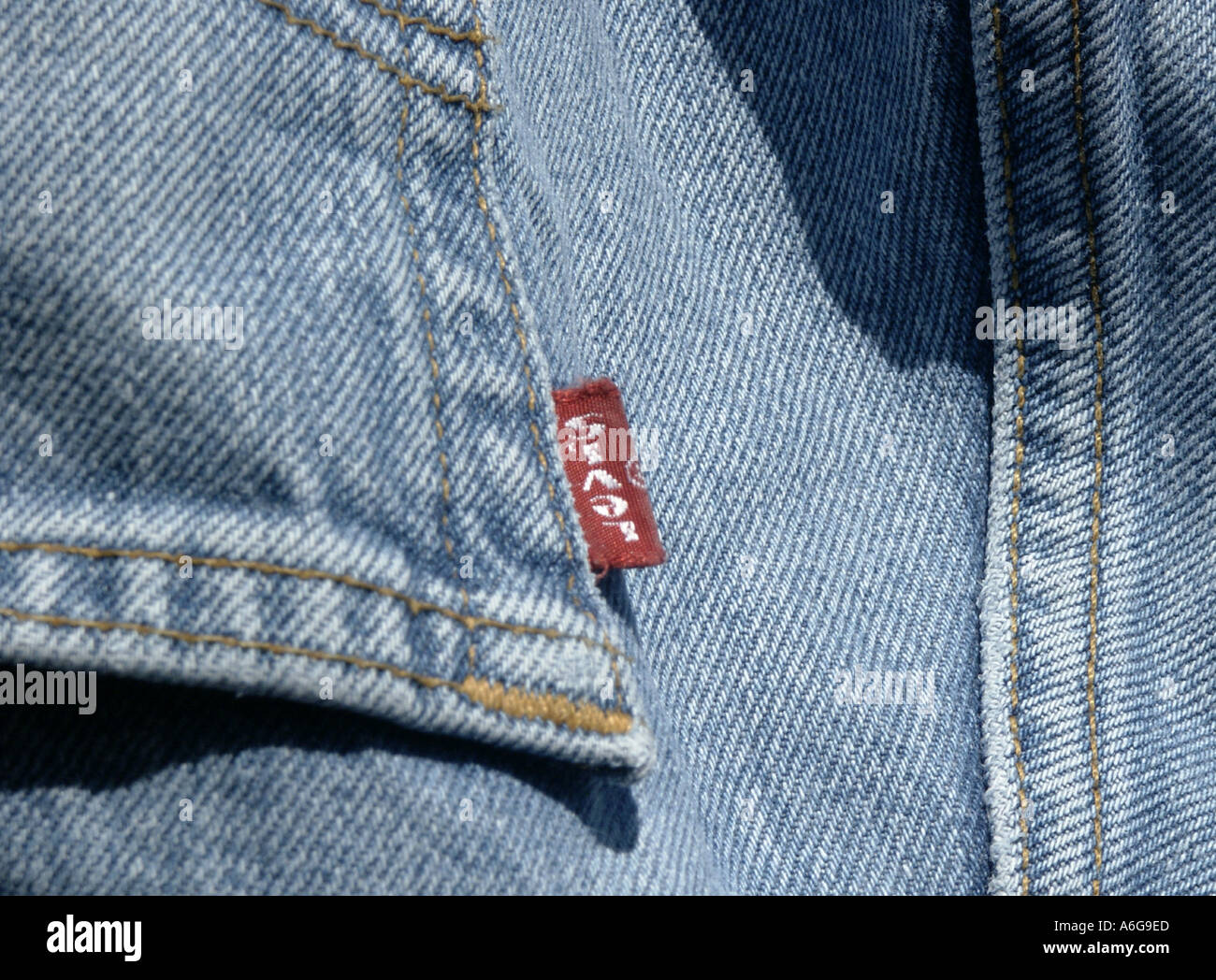 denim jeans levi s red tag blue washed pocket close stitching yellow worn  hang pants seam back rear fabric clothes Stock Photo - Alamy