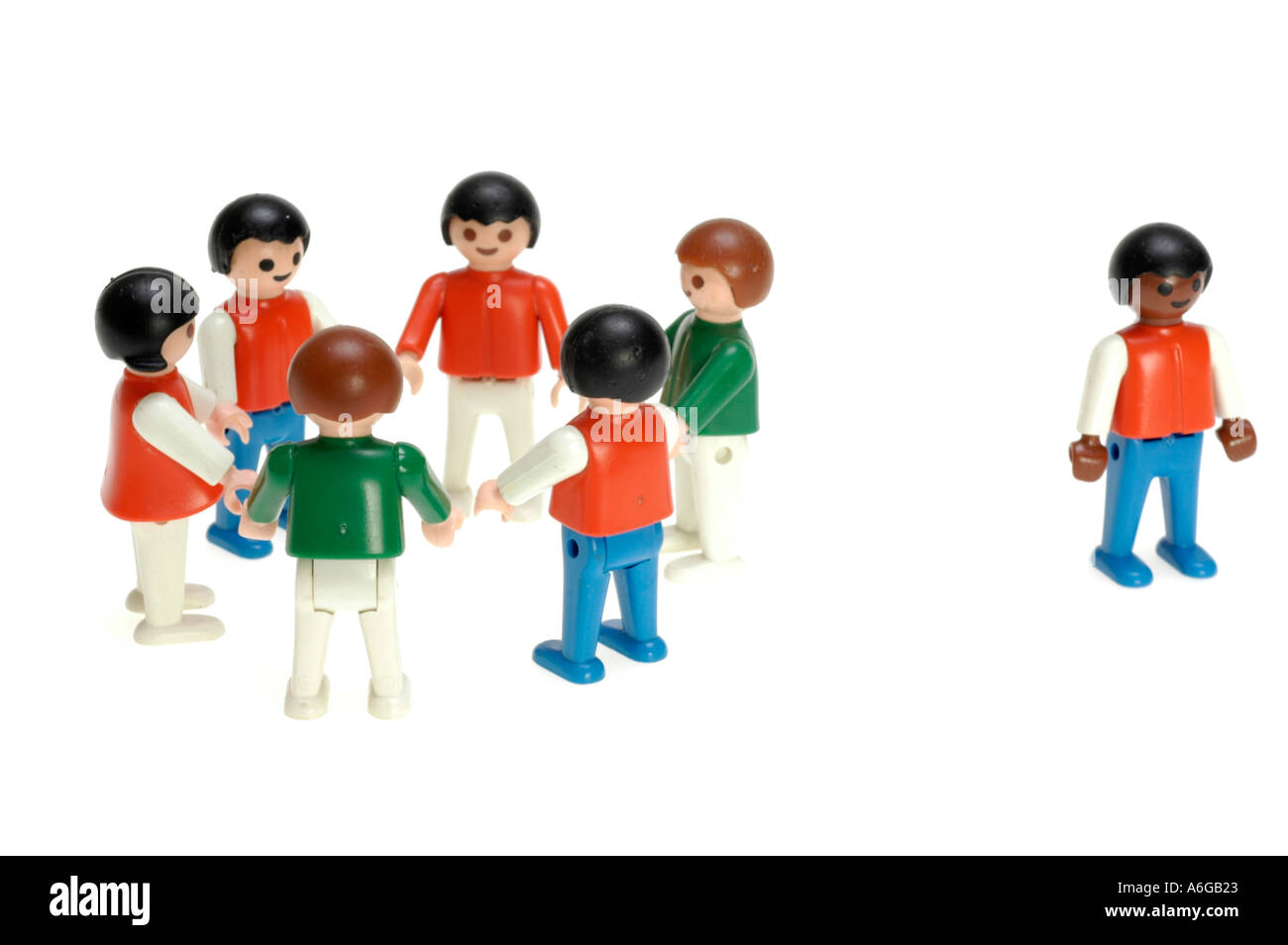 group of white toy figures, circle, single black figure, excluded Stock Photo