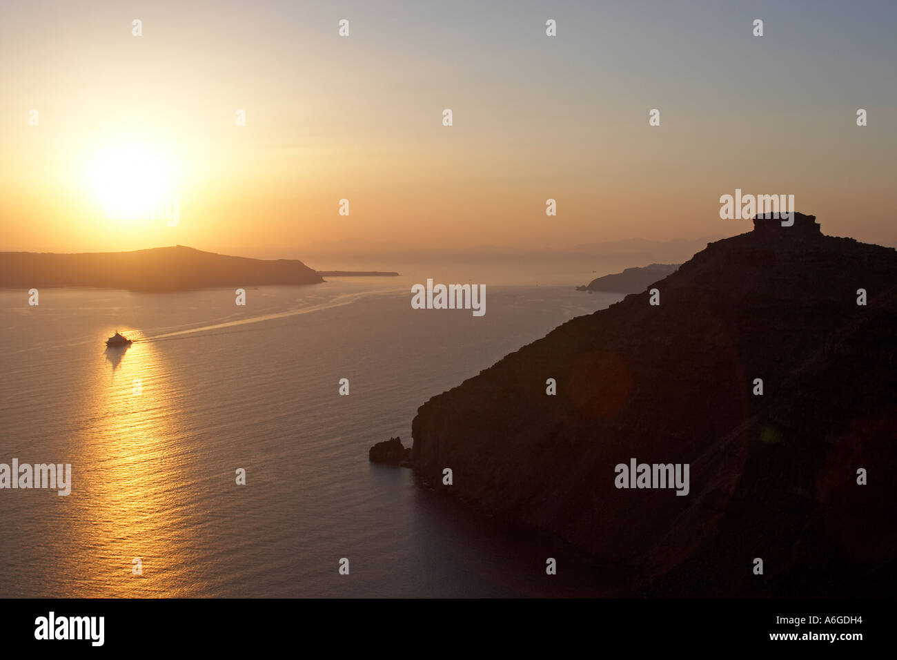 Sunset with sun setting into the Aegean sea Stock Photo