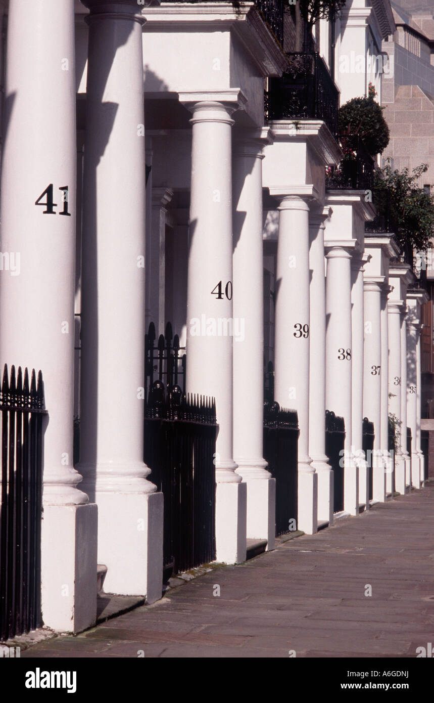 Black street address numbers on line of white columns before Regency homes, Thurloe Square, South Kensington, London SW7 England Stock Photo