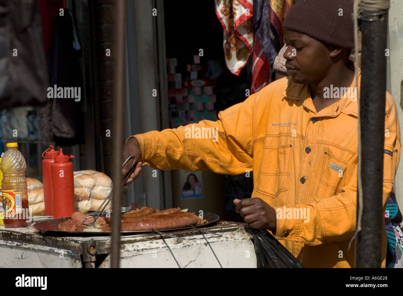 South Africa Johanesburg Alexandra Township street hawker frying saussages at street stall Stock Photo