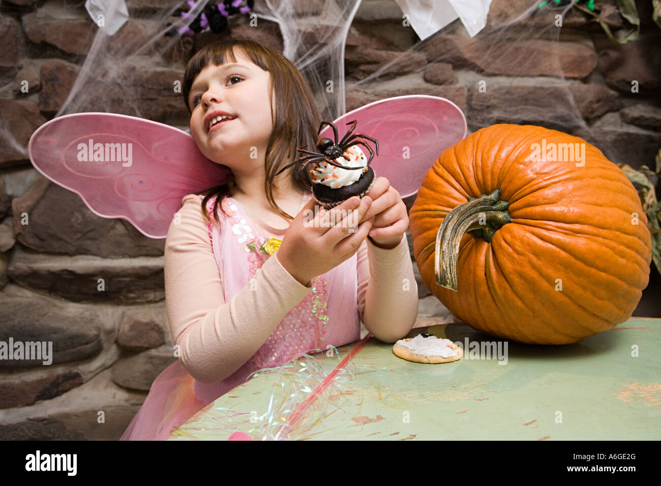 Girl with a spider cake Stock Photo