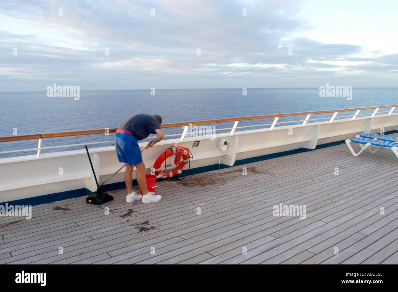 crew cleaning cruise ship for the paying people by washing ship deck in