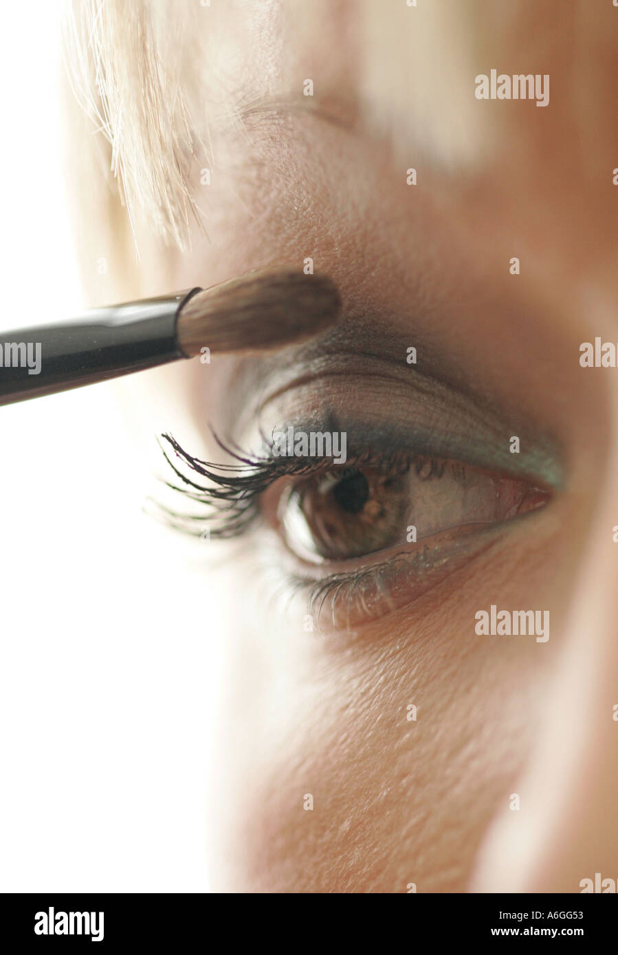Close up of woman applying eyeshadow Stock Photo