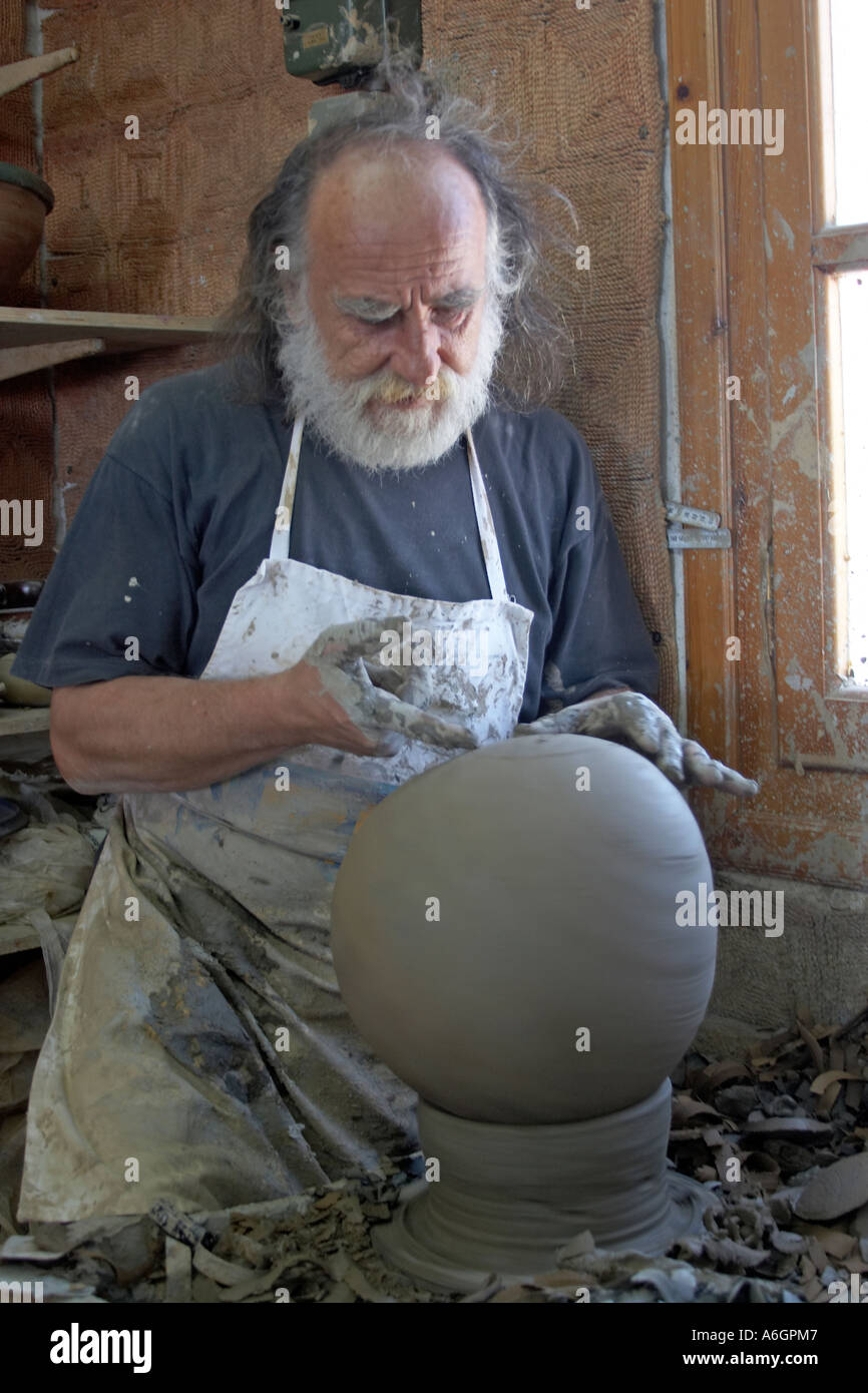 Portrait of Andreas Makaris a potter with beard making pottery from