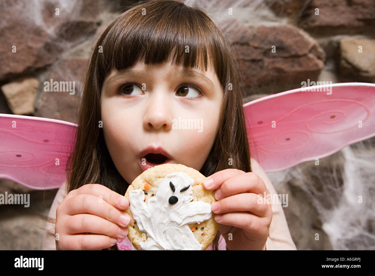 Girl holding a halloween cookie Stock Photo