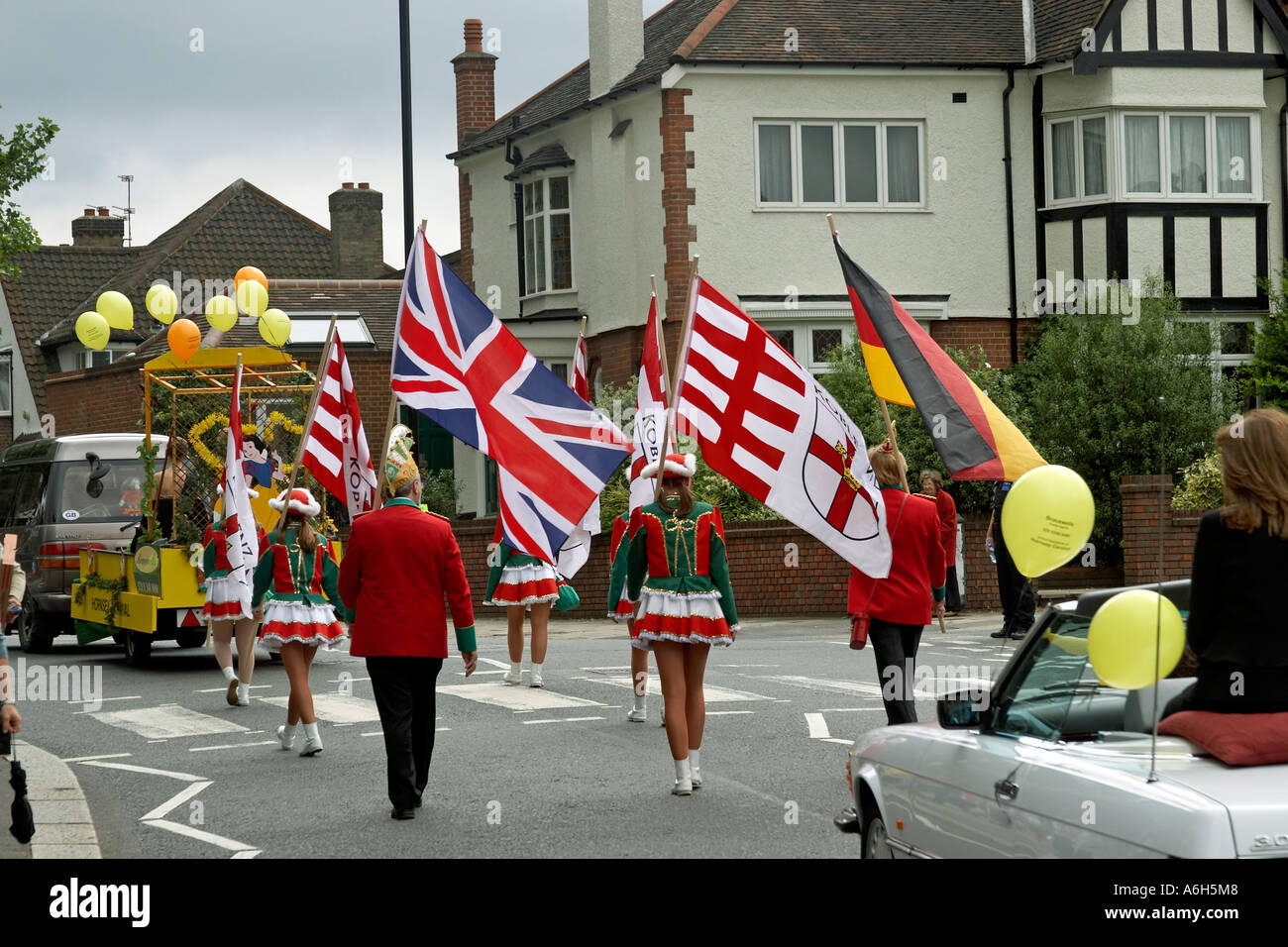 Hornsey Carnival parade with flags through streets of Muswell Hill London N10 England Stock Photo