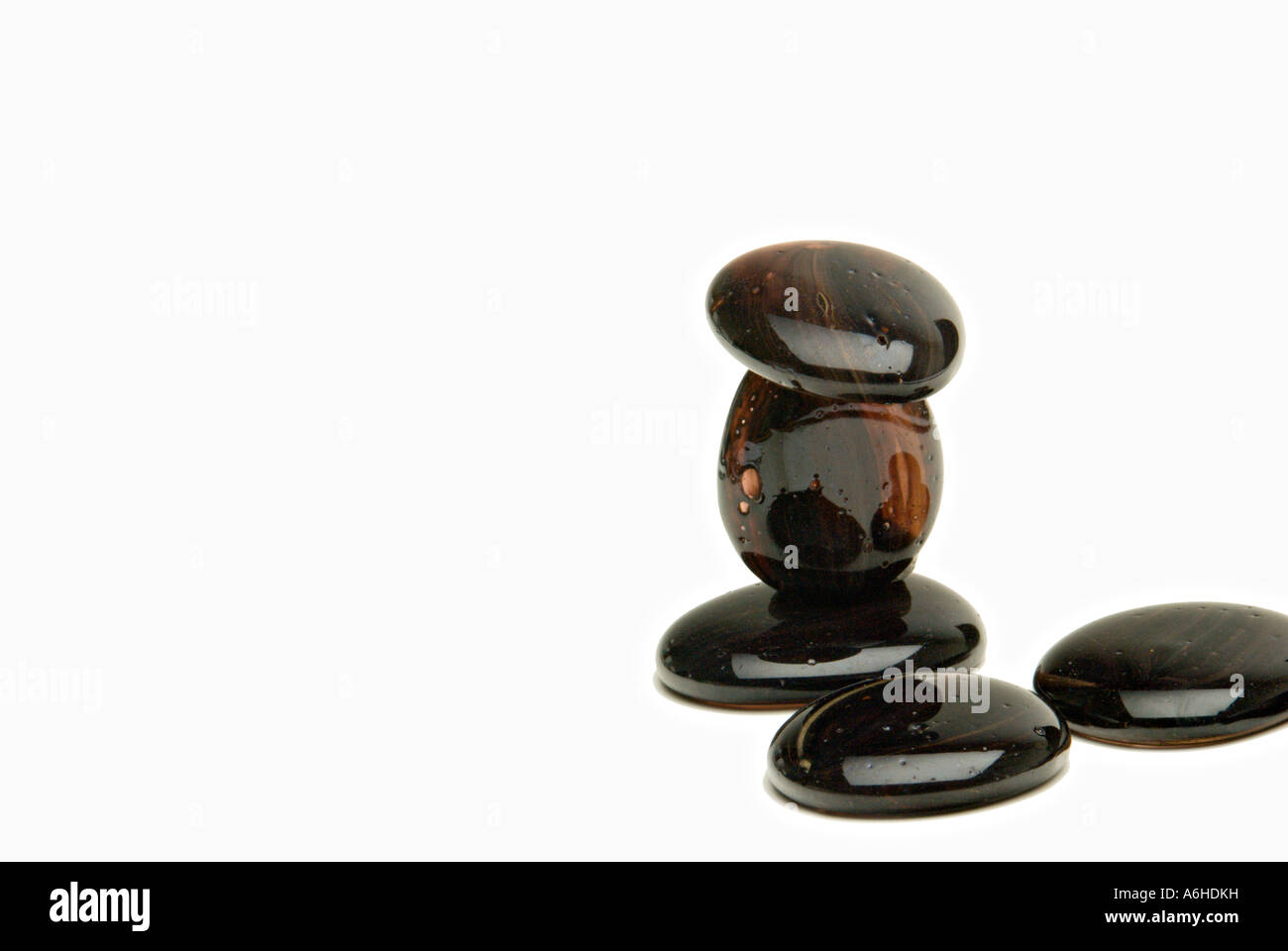 Black Smooth Pebbles on White Background Zen Stock Photo