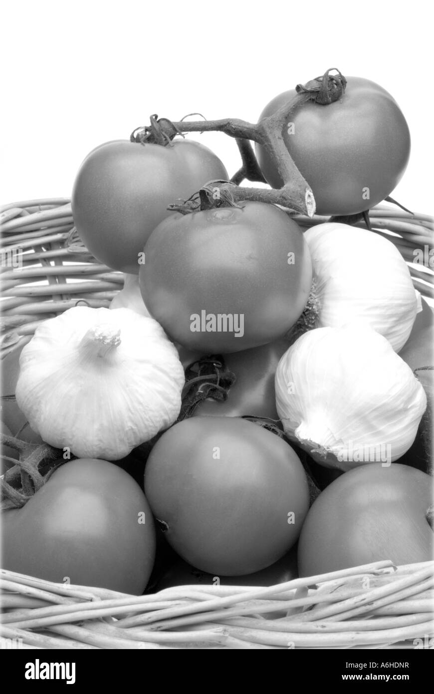 Basket of tomatoes and garlic in black and white High Key Stock Photo ...