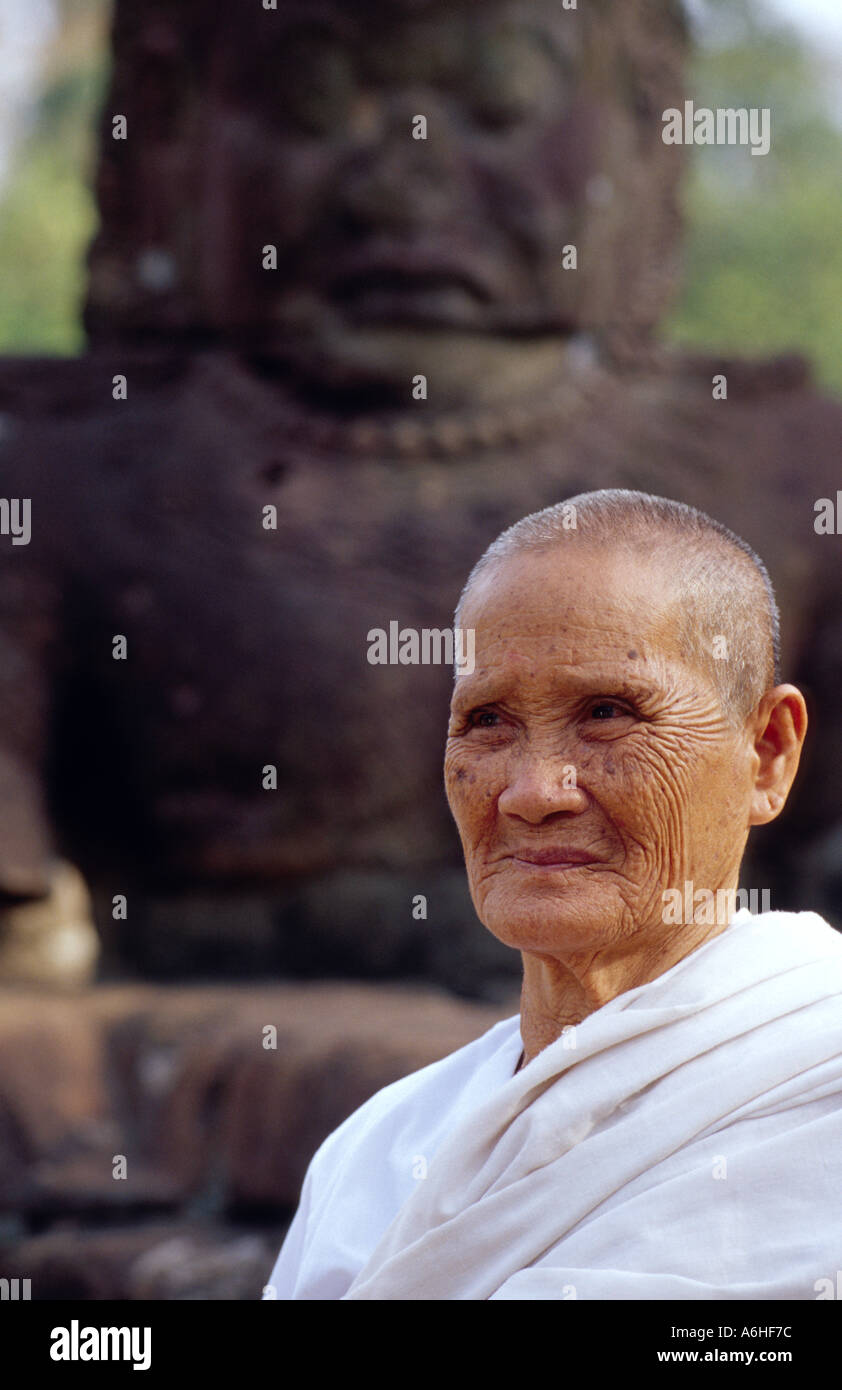 Old Person in Front of Religious Statue Stock Photo