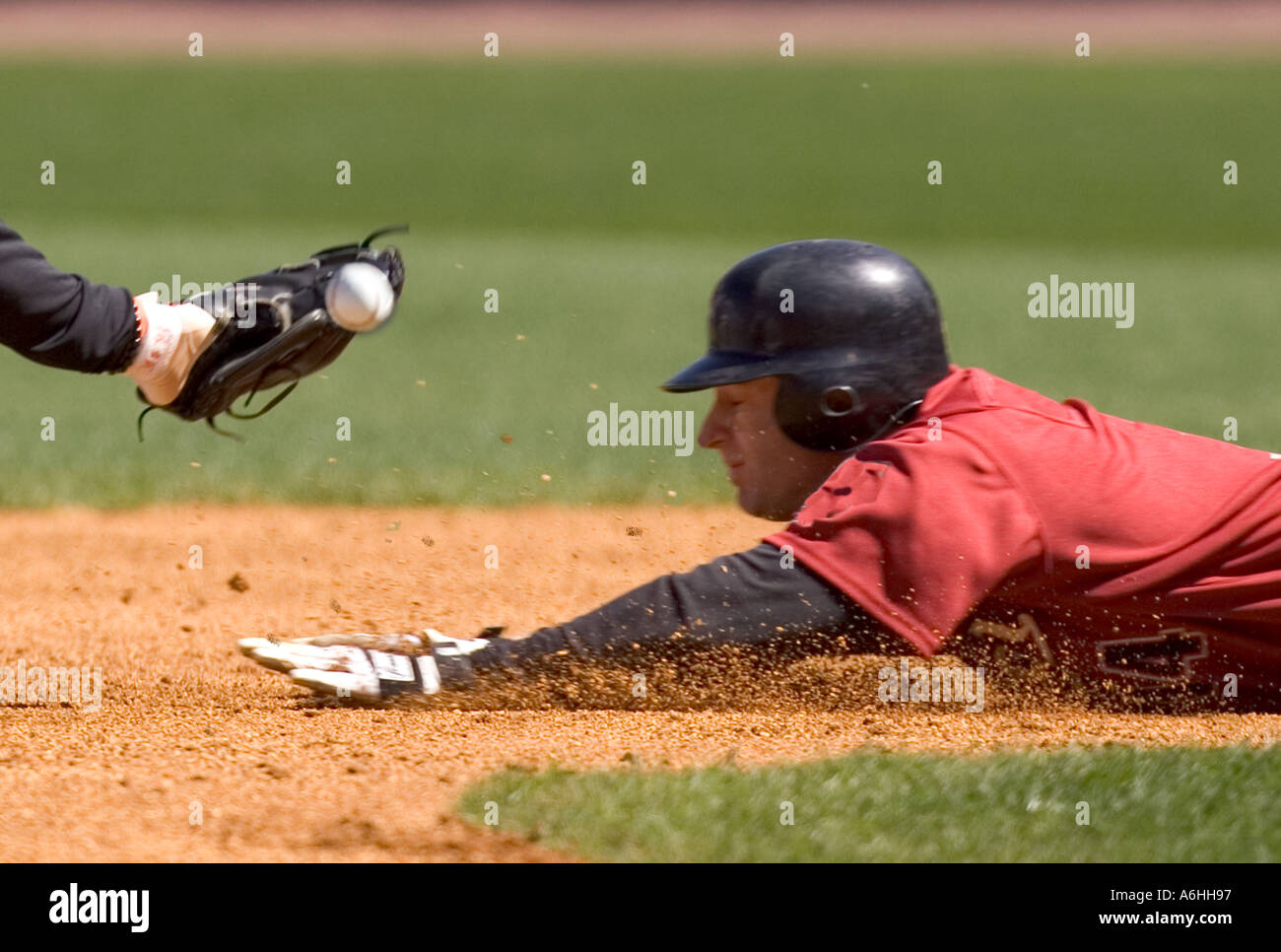 Baseball player sliding into a base Stock Photo