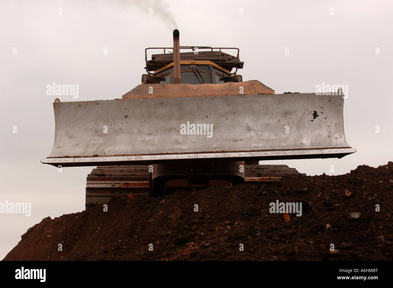 Bulldozer shifting earth on a landfill site in England, Great Britain Stock Photo