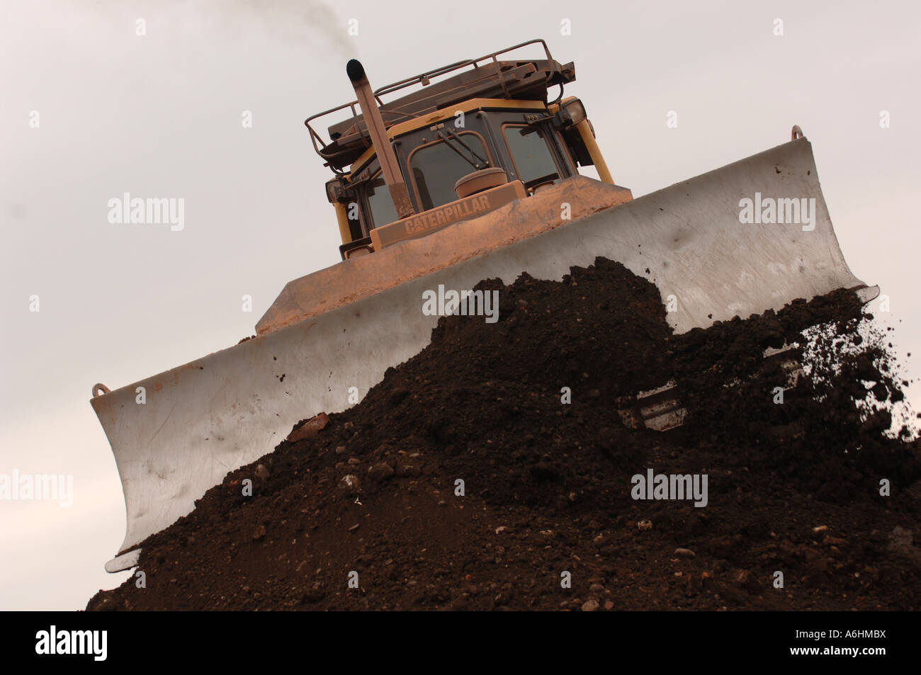 Bulldozer shifting earth on a landfill site in England, Great Britain Stock Photo
