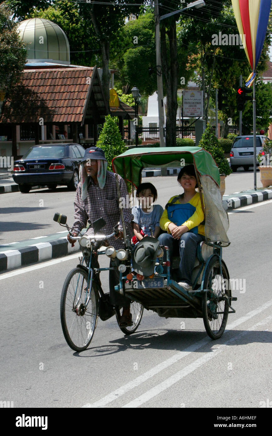 Woman and child ride in rickshaw Kota Bharu Malaysia Stock Photo - Alamy