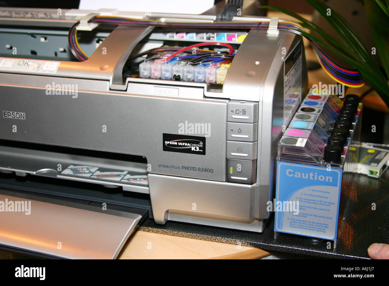 Epson R2400 inkjet printer fitted with modern automatic ink refill kit from  bottles through pipes Stock Photo - Alamy