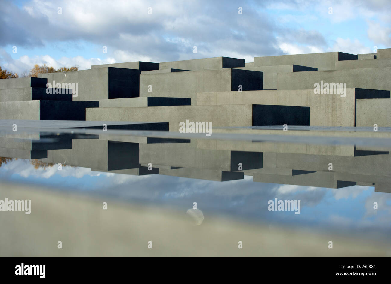 Reflection of the Stele of the Holocaust memorial in a water surface on a concrete stele, Berlin, Germany. Stock Photo