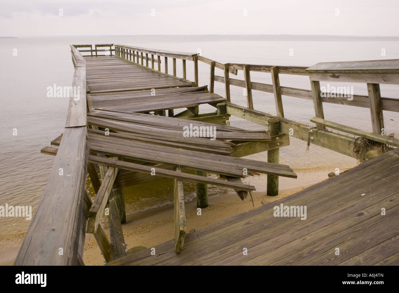 VIRGINIA USA Wooden pier damaged by hurricane on the beach at Woodbridge State Park on the Potomac RIver Stock Photo