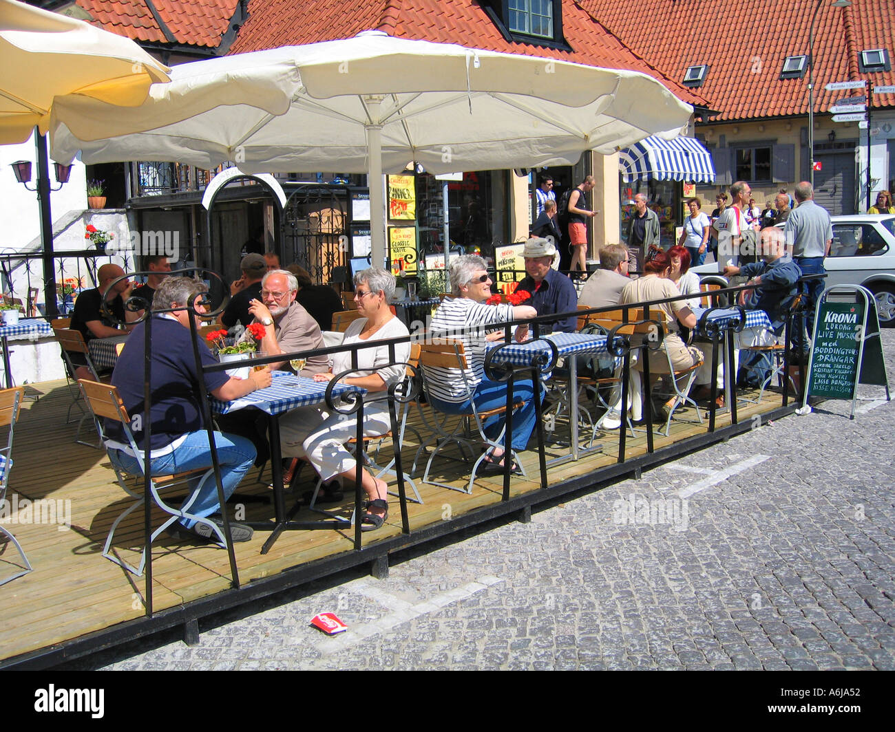 People eating in an outdoor restaurant on the main square of the medieval  town of Visby on Gotland Island Sweden Stock Photo - Alamy