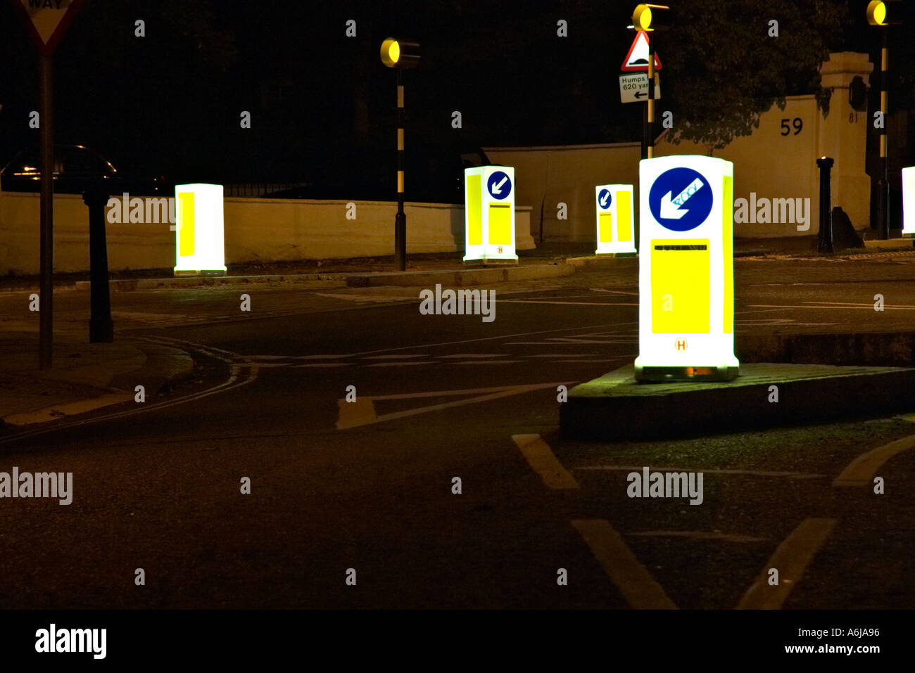 road street lit up light bollards signs empty direct direction decision