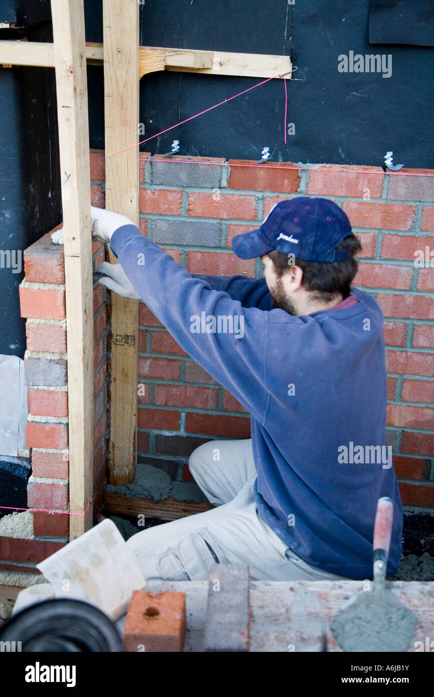 Immigrant Workers Finishing Brick Walls Building 4 Stock Photo Alamy
