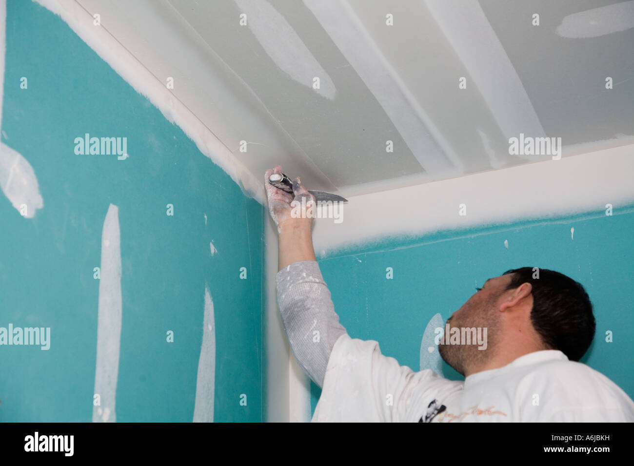 Immigrant Worker Applying Drywall Joint Compound Building 1 Stock