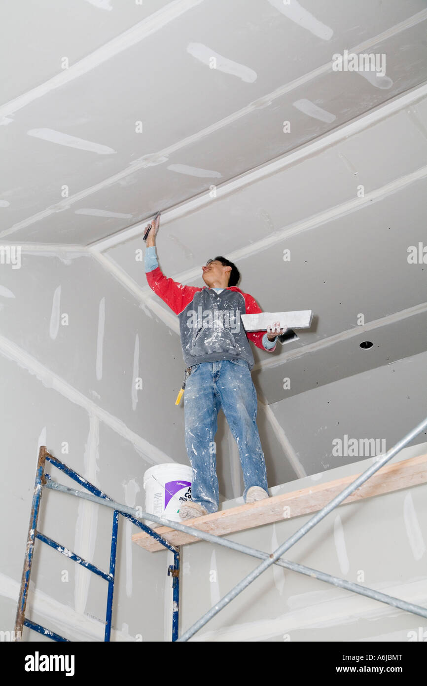 Immigrant Worker Applying Drywall Joint Compound Building 1 Stock