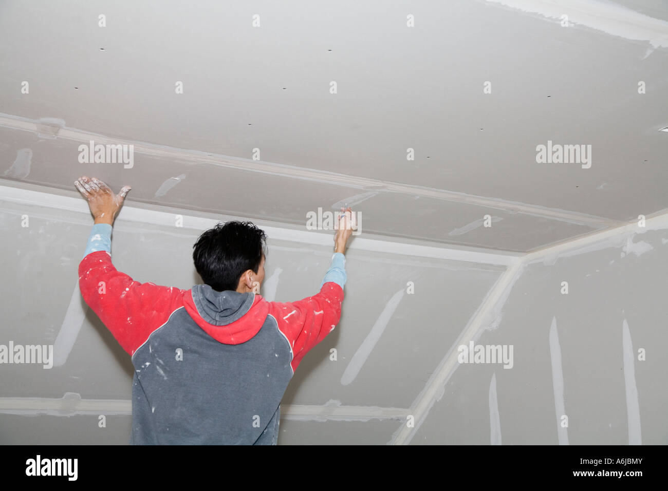 Immigrant Worker Applying Drywall Joint Compound Building 1 Stock
