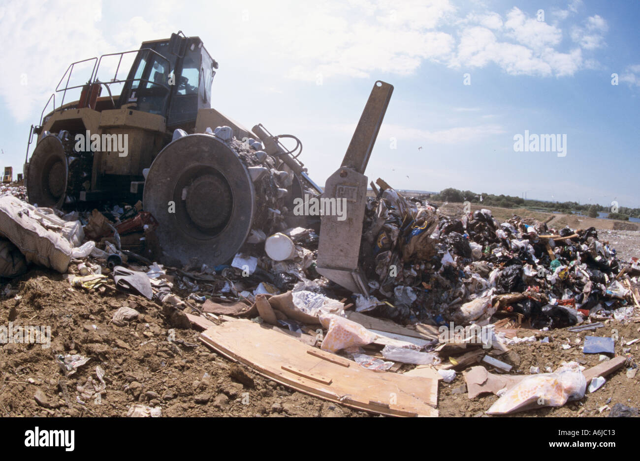 Bulldozer crushes rubbish at Landfill site Mucking on Thames London uk Stock Photo