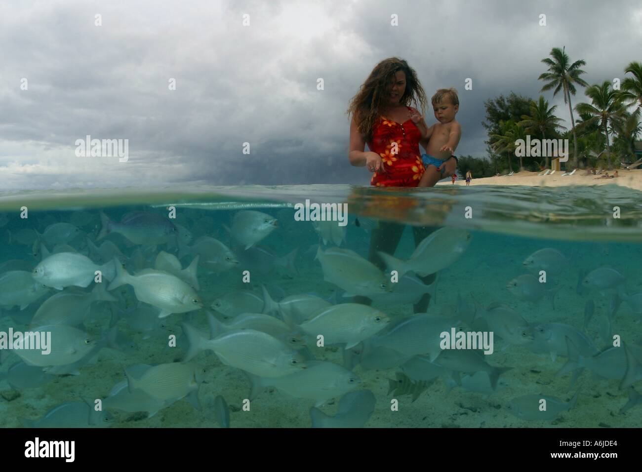 WOMAN AND BOY MR WITH FISH COOK ISLANDS Stock Photo