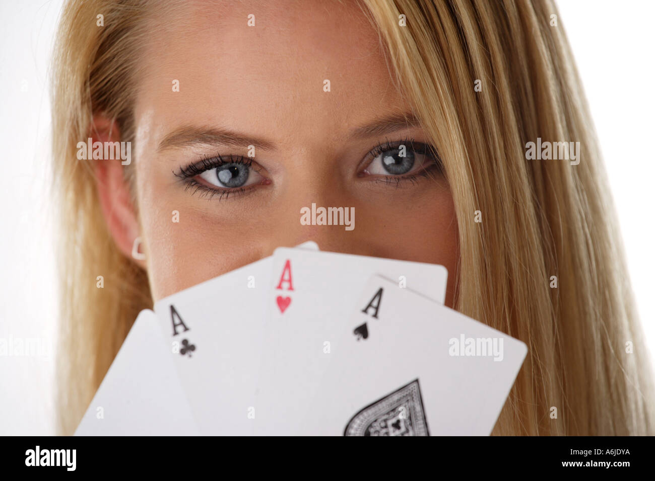 young woman holding playing cards in front of her mouth Stock Photo