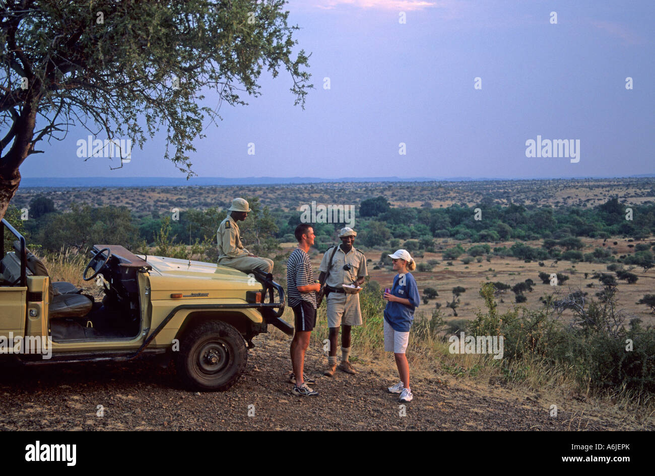 Guests having sundowners while on game drive. Stock Photo