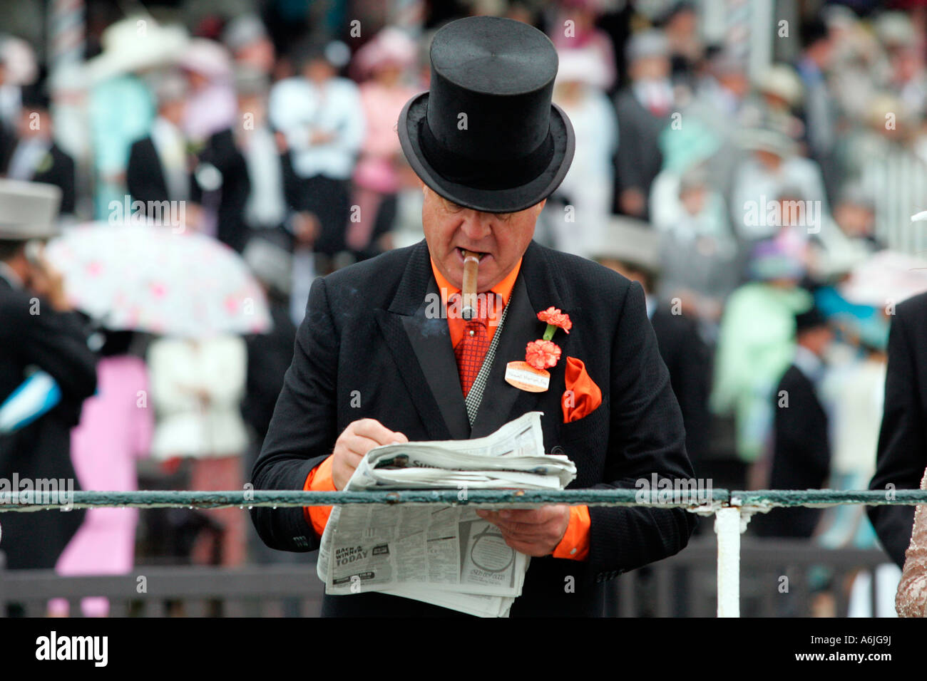 Man smoking a cigar, reading a newspaper at Royal Ascot horse race, York, Great Britain Stock Photo