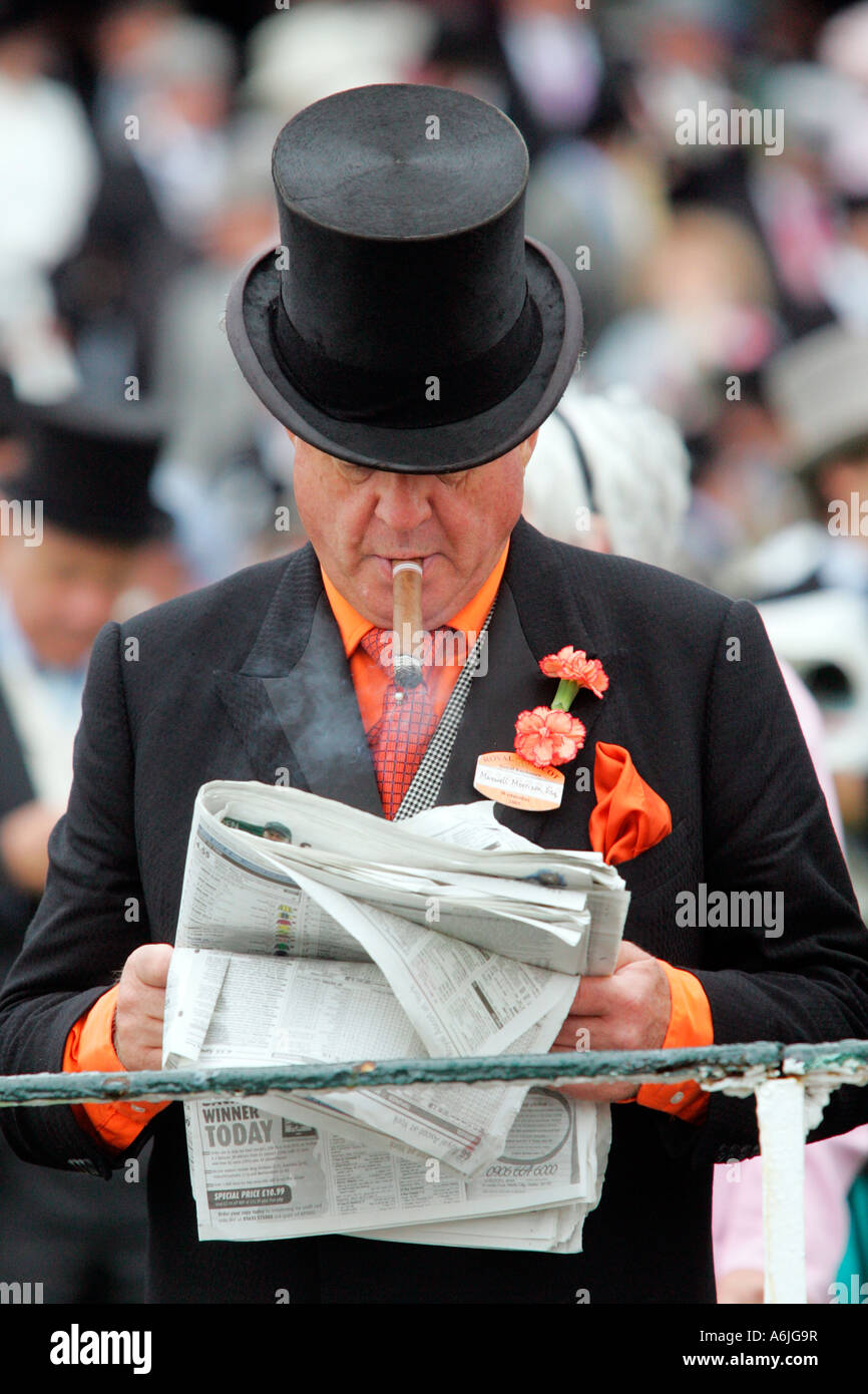Man smoking a cigar, reading a newspaper at Royal Ascot horse race, York, Great Britain Stock Photo