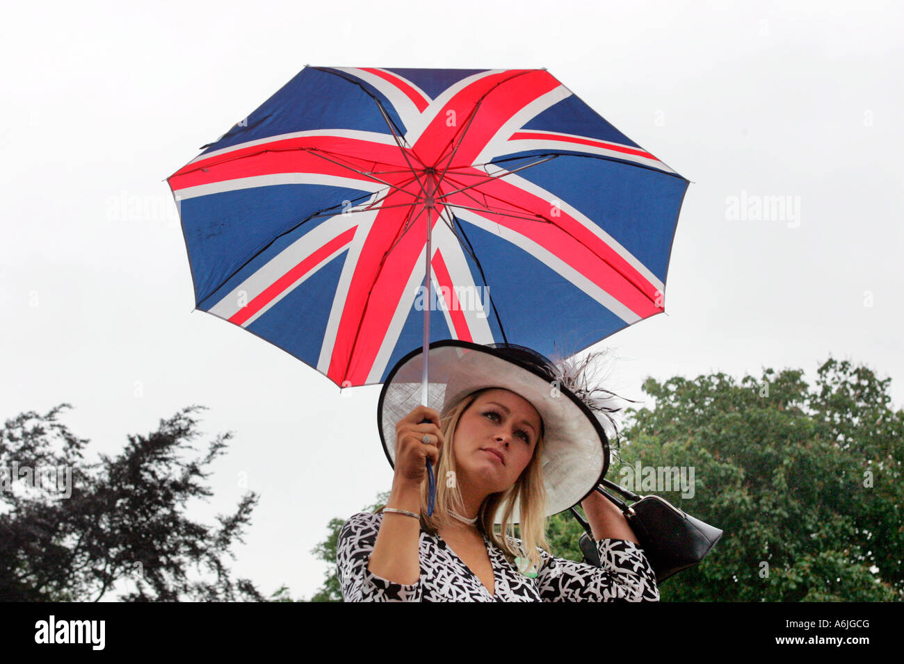 Woman holding an umbrella in British national colours, Royal Ascot at York, Great Britain Stock Photo