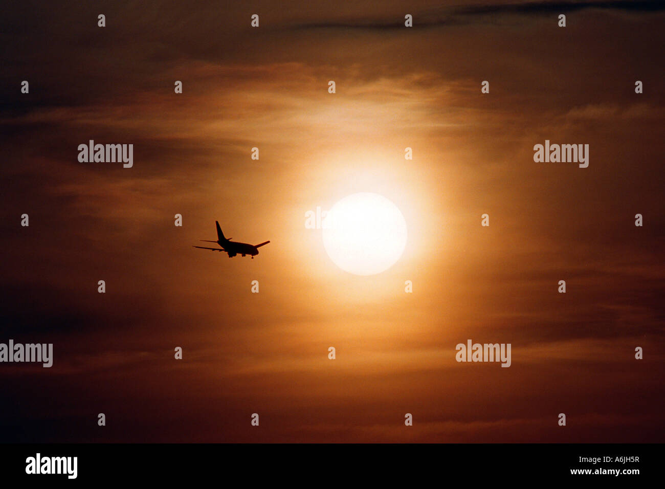 A plane at sunset Stock Photo - Alamy