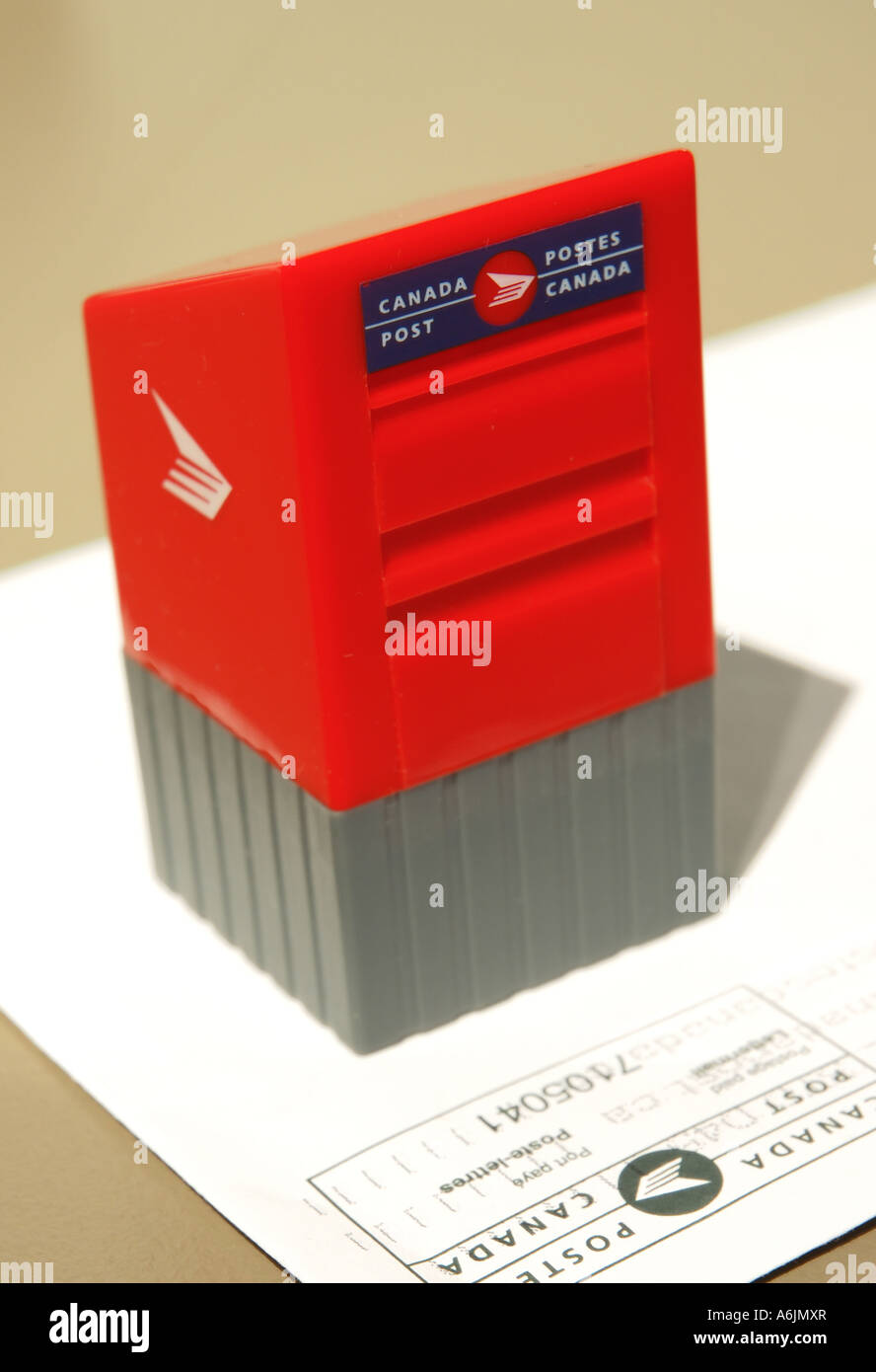 Miniature Canada Post stamp dispenser in the shape of a mailbox and 51 cent  stamps Stock Photo - Alamy