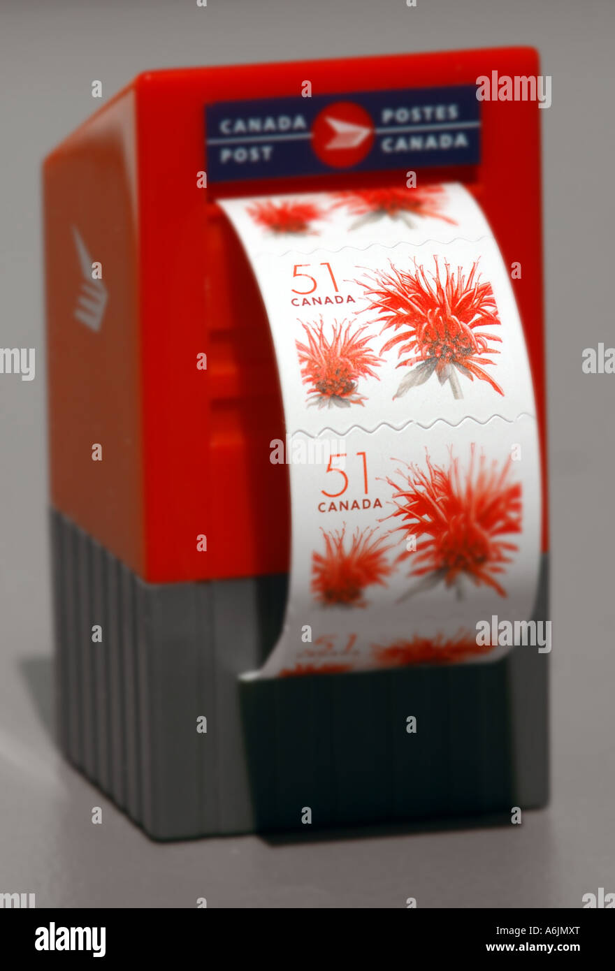 Miniature Canada Post stamp dispenser in the shape of a mailbox and 51