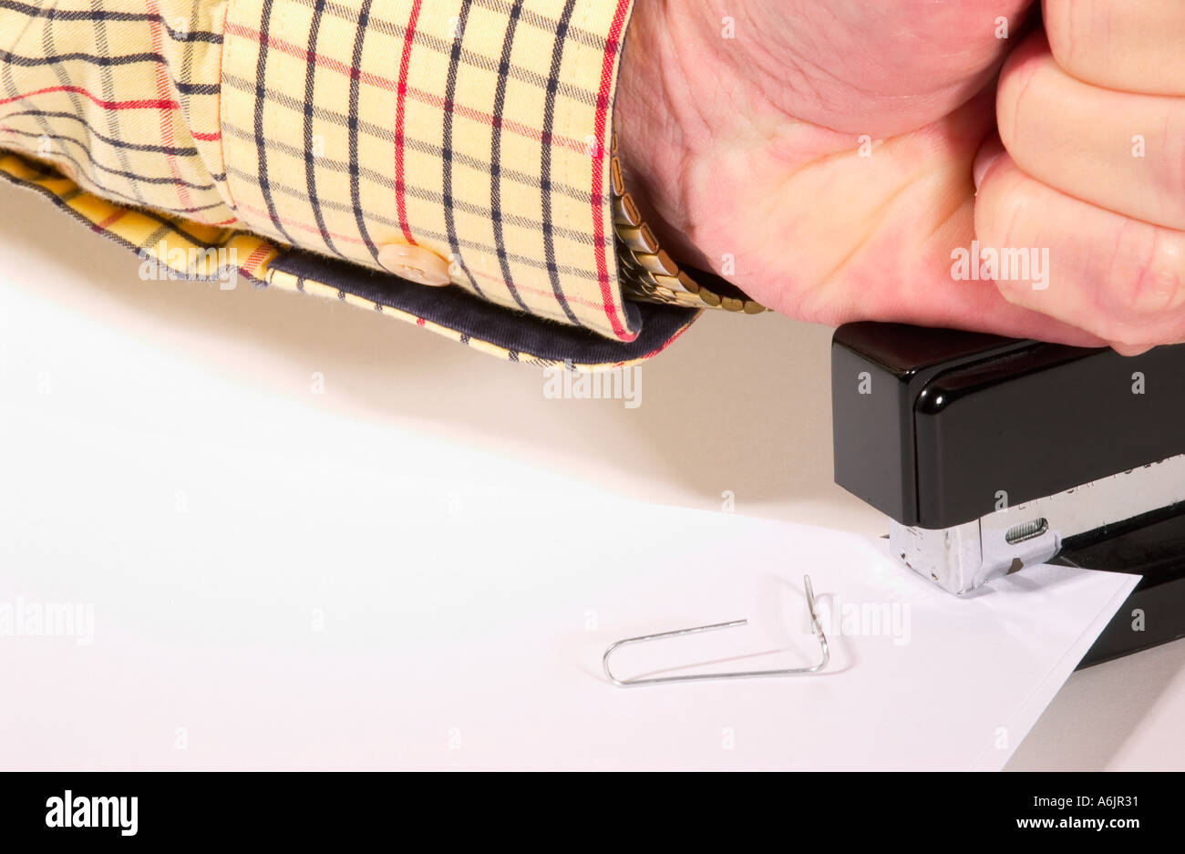 Stock Photo of Caucasian Male Stapling Paper USA Stock Photo - Alamy