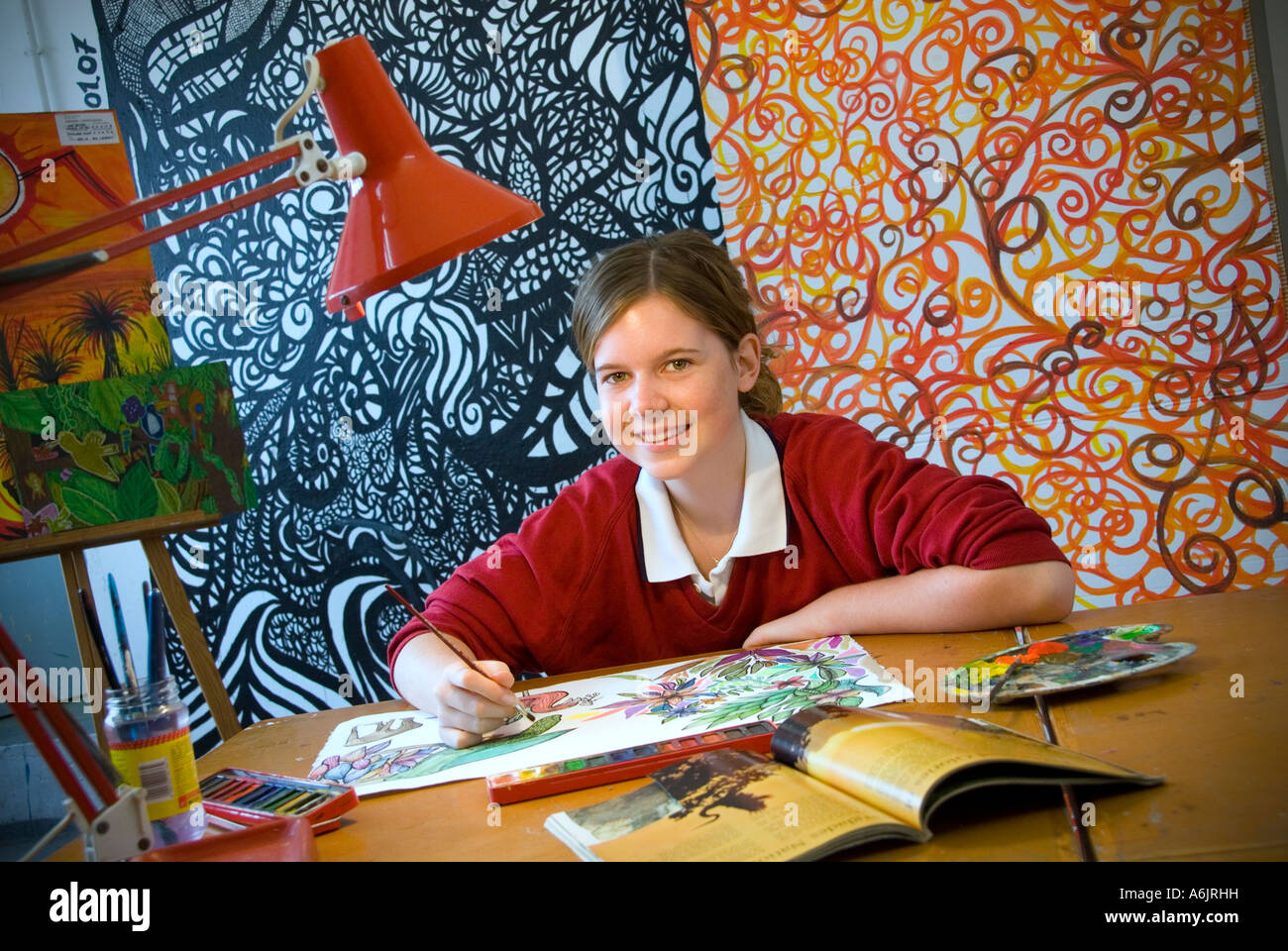 ART CLASS STUDENT ARTWORK Smiling teenage girl student working on her