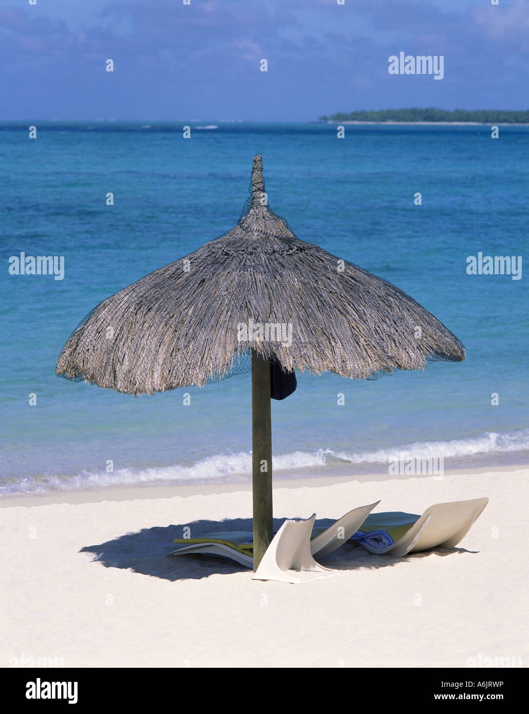 Straw umbrella and sun beds, Silver Beach Hotel, Trou D'eau Douce, Republic of Mauritius Stock Photo