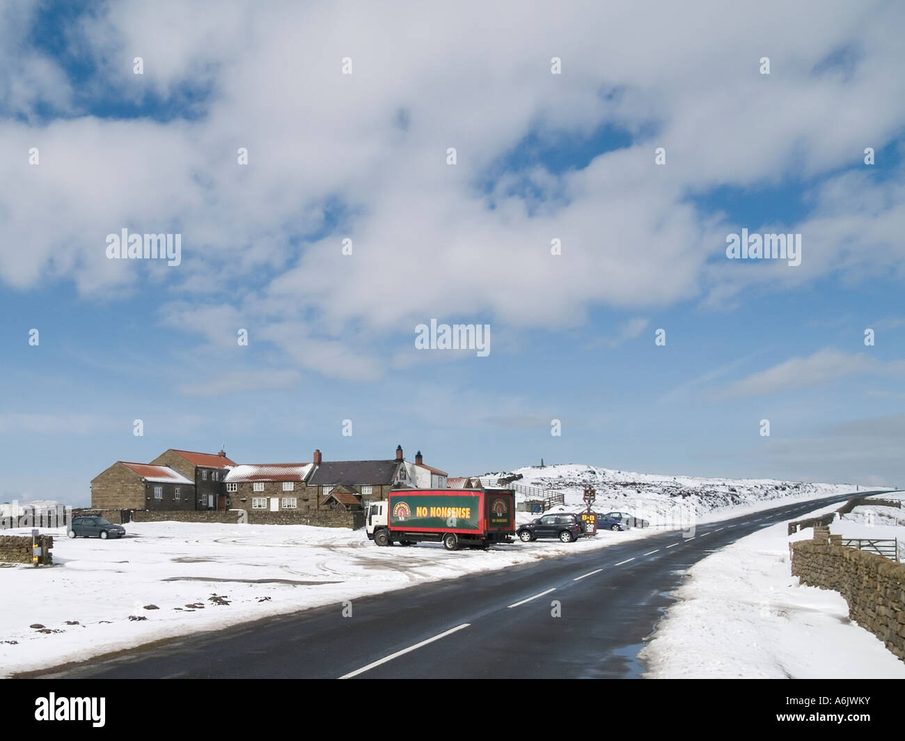 A lorry delivering beer to the Lion Inn an isolated pub on the North Yorkshire Moors in snowy weather Stock Photo