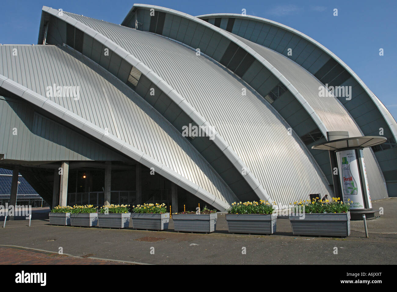 West end of Clyde Auditorium (also called Armadillo) in Glasgow Exhibition Centre with flower baskets in the foreground Stock Photo