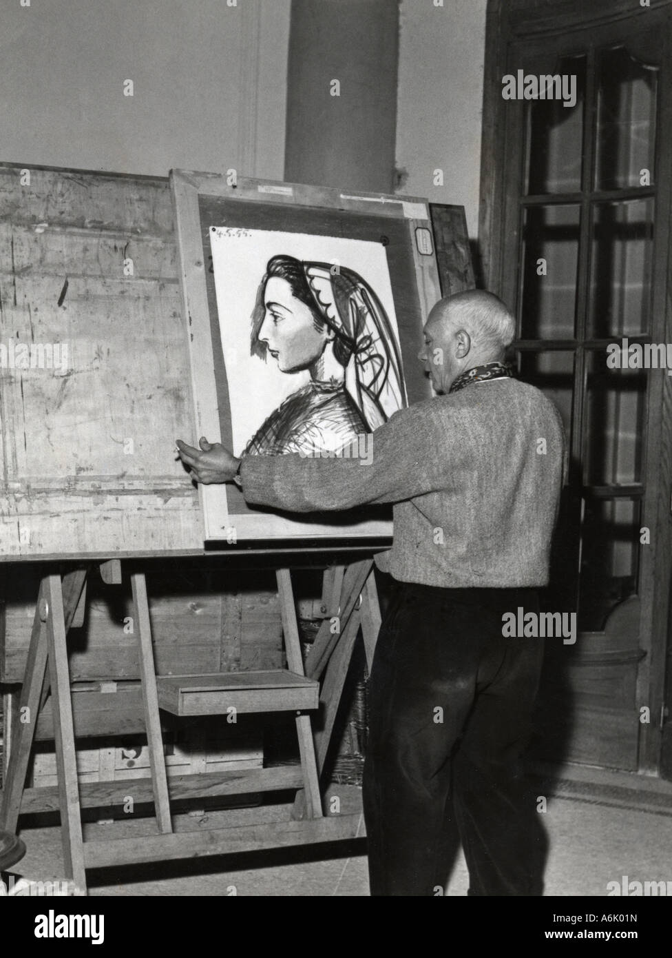 PABLO PICASSO Spanish artist at his Cannes villa with a portrait of his companion Louise dated 4 May 1955 Stock Photo