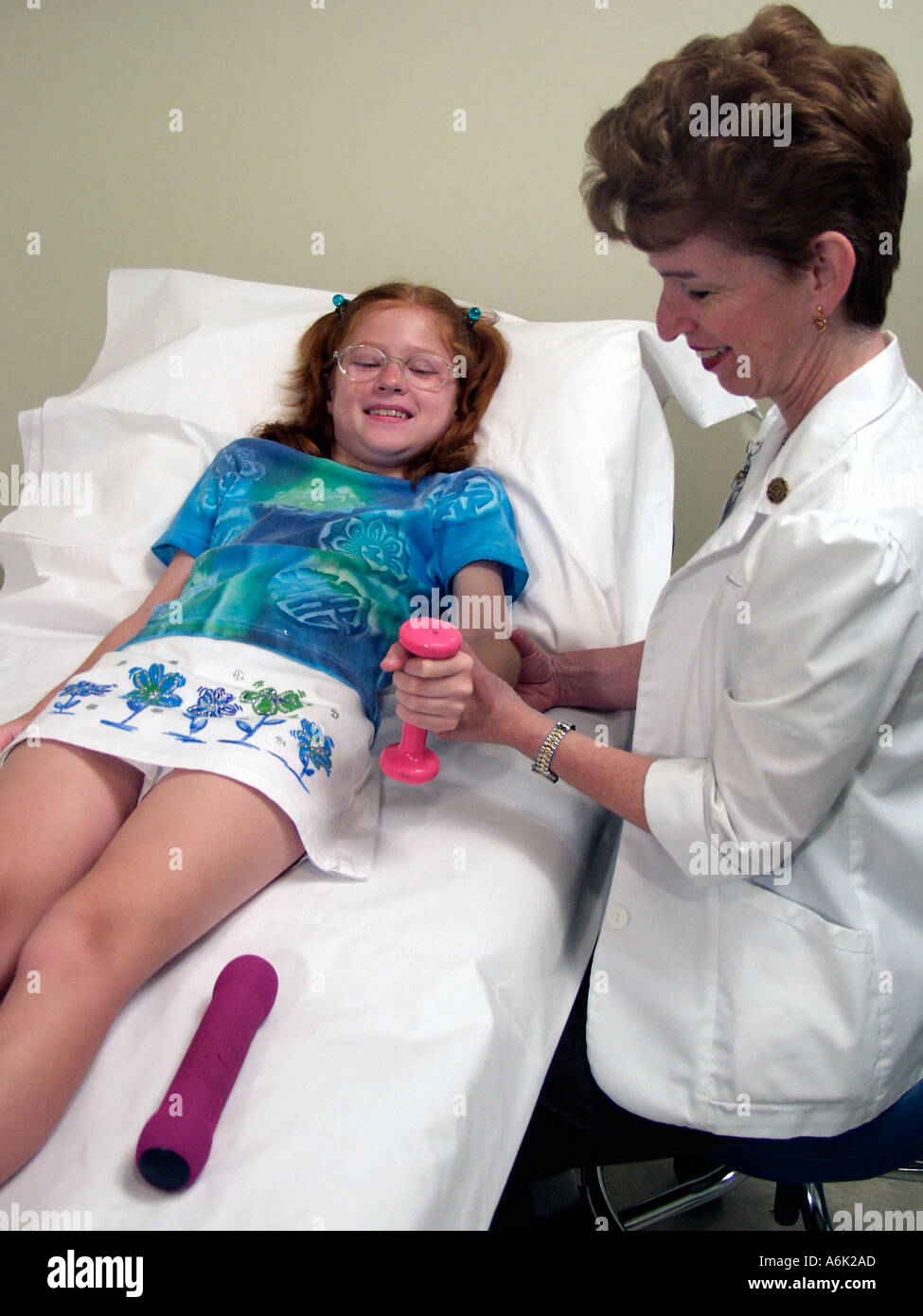 Physical therapist giving a young girl a treatment for a mending broken