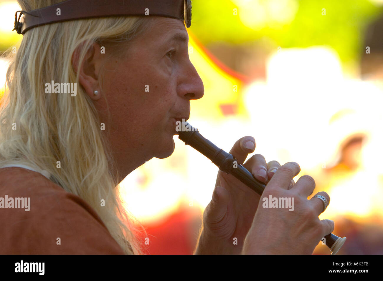 Medieval flute player close up of musician, man with long blonde hair, in  front of blurred background in Monflanquin Aquitaine south west France eu  Stock Photo - Alamy