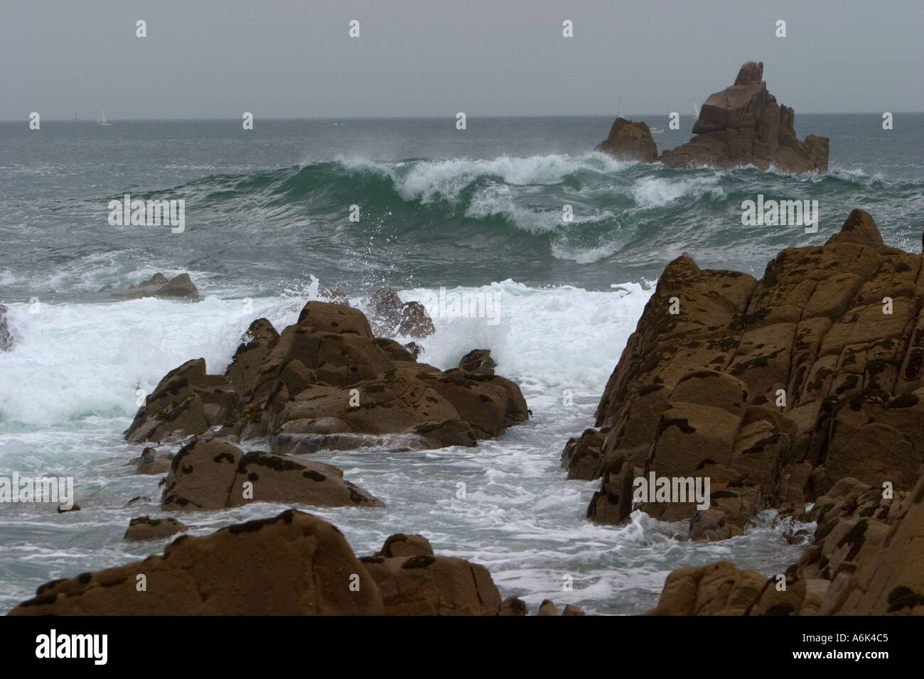 Rough sea with waves breaking on rocks on the Granite Coast in Brittany ...