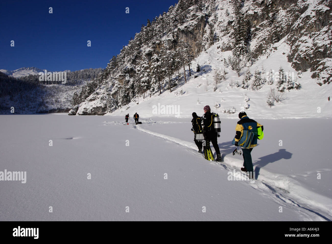 scuba diver walking on a frozen lake Stock Photo