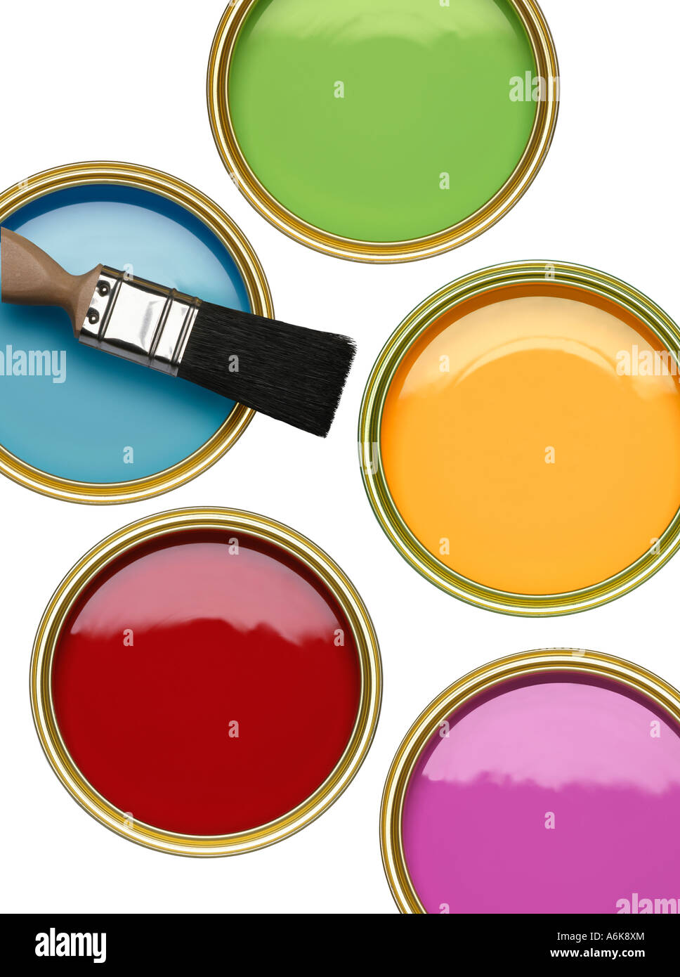 TINS OF BLUE GREEN RED YELLOW AND PURPLE PAINT WITH BRUSH ON WHITE BACKGROUND Stock Photo