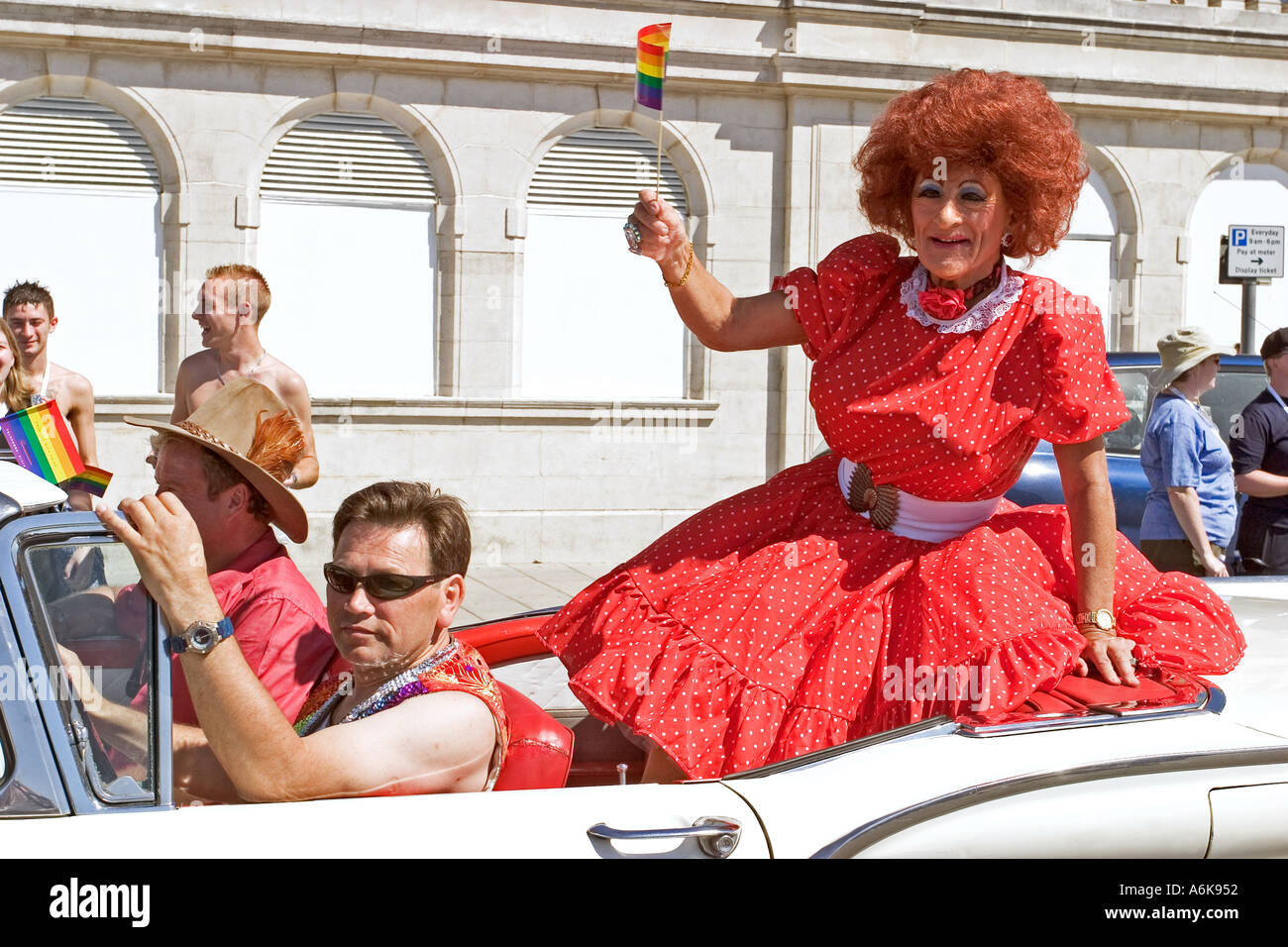 dressed-up-in-bright-red-dress-being-driven-through-parade-gay-pride-A6K952.jpg